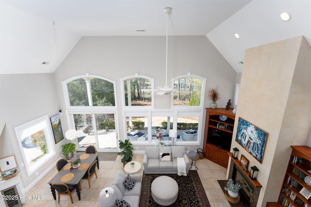 living room with high vaulted ceiling, recessed lighting, visible vents, and plenty of natural light