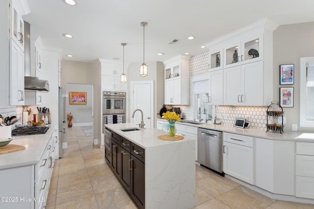 kitchen featuring stainless steel appliances, white cabinetry, and tasteful backsplash