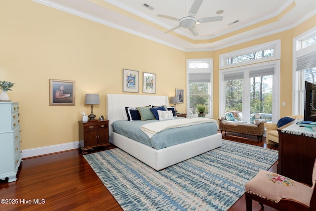 bedroom with dark wood-style floors, ornamental molding, multiple windows, and visible vents