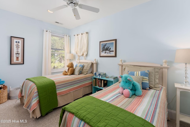 carpeted bedroom with visible vents and a ceiling fan