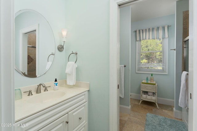 bathroom with vanity and baseboards