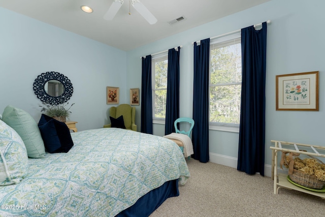 bedroom featuring light carpet, baseboards, visible vents, and a ceiling fan