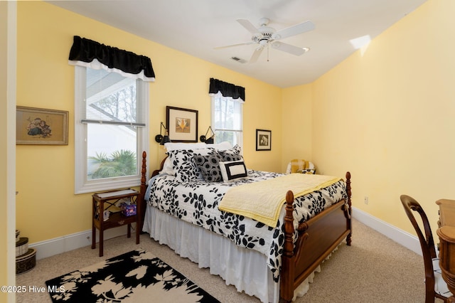 bedroom featuring ceiling fan, light colored carpet, and baseboards