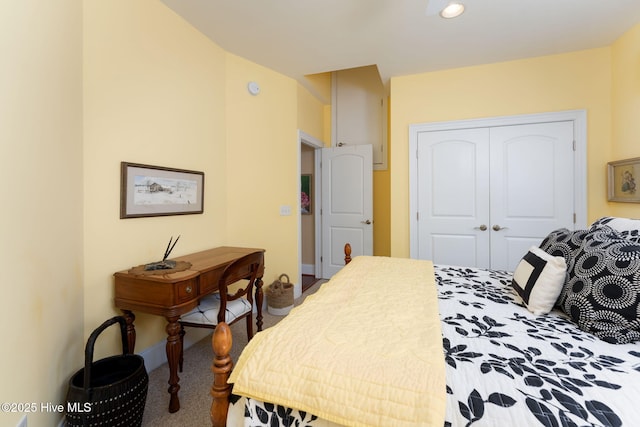 bedroom with carpet floors, a closet, and baseboards