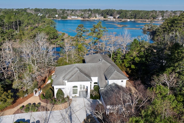 bird's eye view with a water view and a wooded view