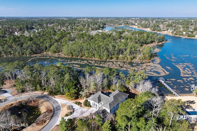 aerial view with a water view and a forest view