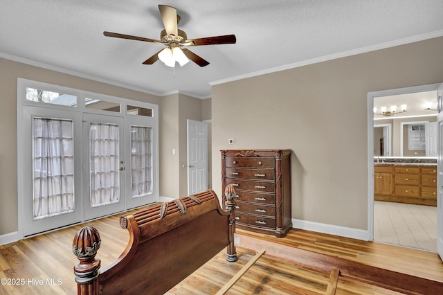 bedroom with ornamental molding, ceiling fan, ensuite bath, light wood-type flooring, and baseboards