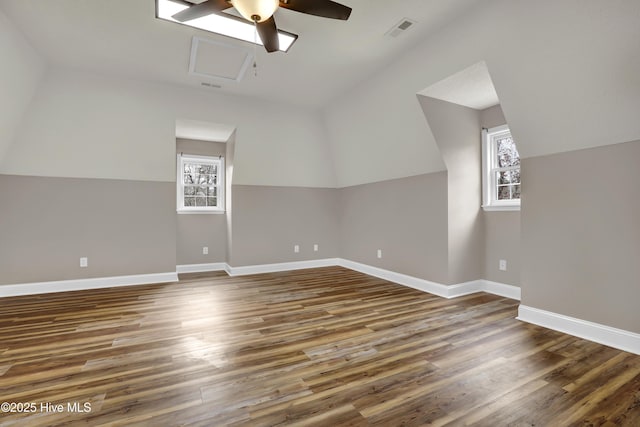 bonus room featuring baseboards, visible vents, and wood finished floors