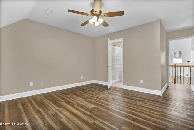 spare room featuring ceiling fan, dark wood-type flooring, and baseboards