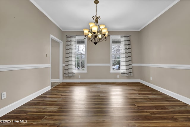 unfurnished dining area featuring a notable chandelier, baseboards, dark wood finished floors, and crown molding