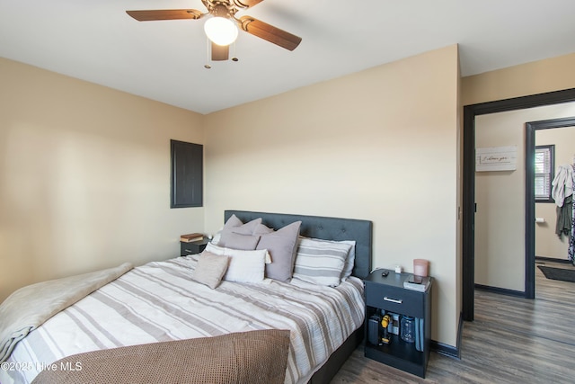 bedroom featuring ceiling fan, baseboards, and wood finished floors