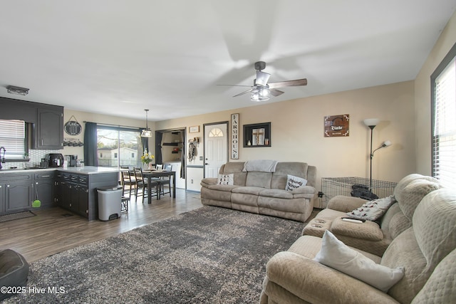 living area featuring dark wood-style floors and a ceiling fan