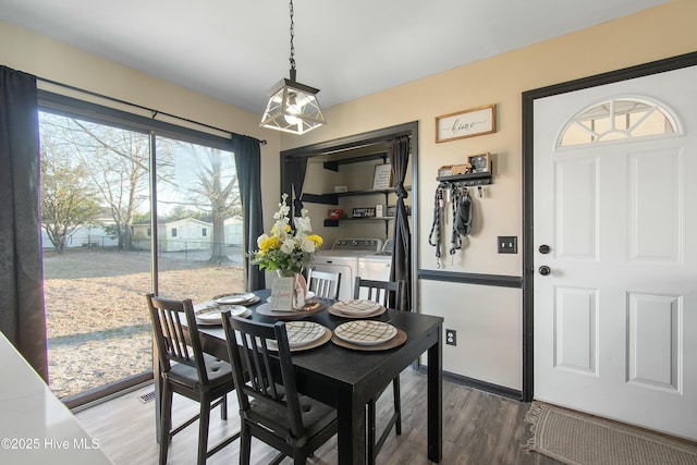 dining area featuring washing machine and dryer and wood finished floors