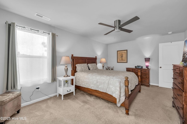 bedroom featuring a ceiling fan, light colored carpet, visible vents, and baseboards