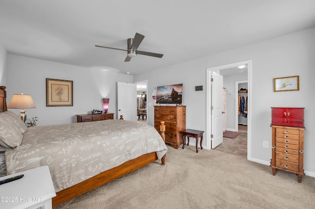 carpeted bedroom featuring a closet, baseboards, ceiling fan, and a spacious closet