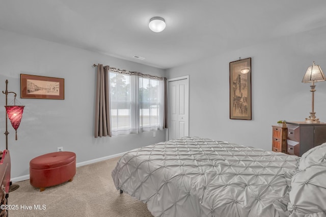 bedroom featuring carpet flooring, baseboards, and a closet