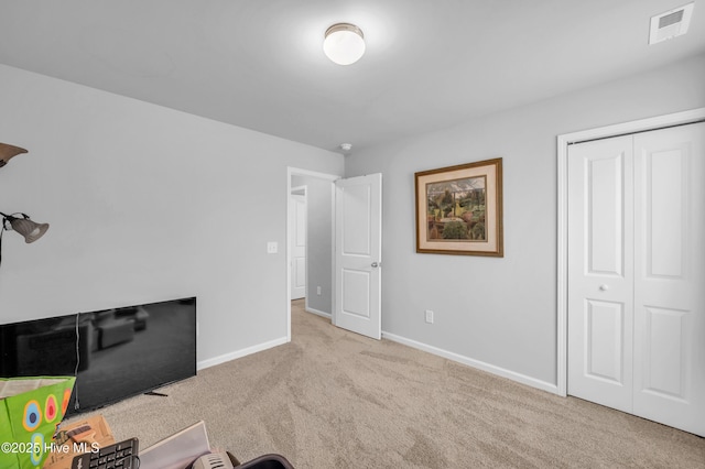 interior space featuring a closet, visible vents, baseboards, and carpet floors