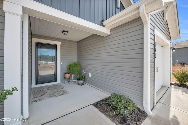 view of exterior entry with board and batten siding