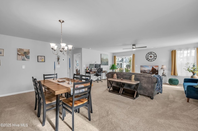 dining room featuring ceiling fan with notable chandelier, baseboards, and light carpet