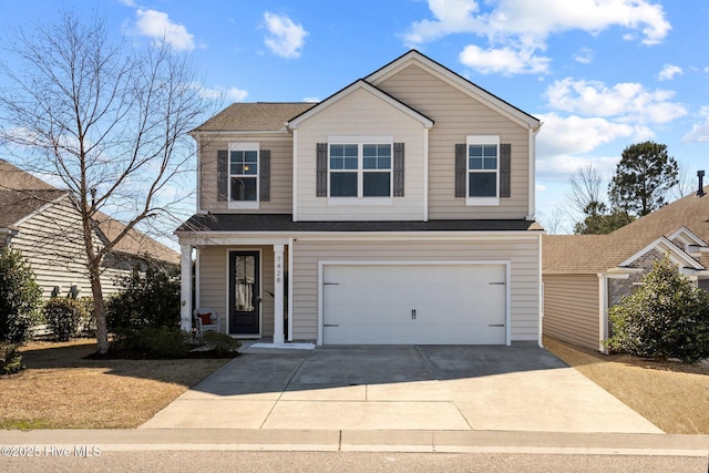 traditional-style home featuring concrete driveway and an attached garage