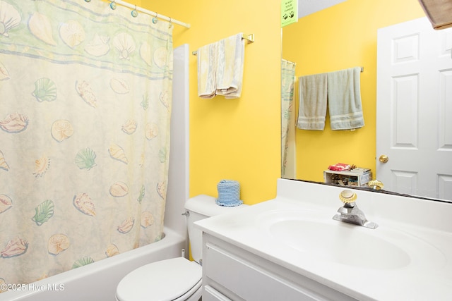 full bathroom with toilet, shower / bath combo with shower curtain, and vanity