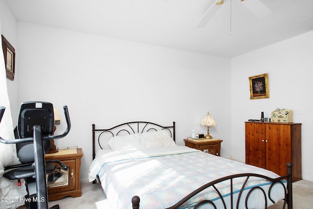 bedroom with a ceiling fan and light colored carpet