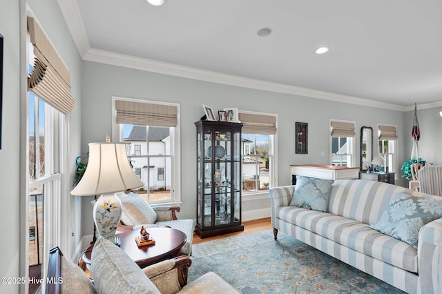 living room featuring baseboards, ornamental molding, wood finished floors, and recessed lighting