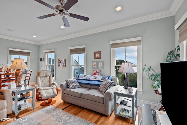 living area featuring recessed lighting, a ceiling fan, baseboards, ornamental molding, and light wood finished floors