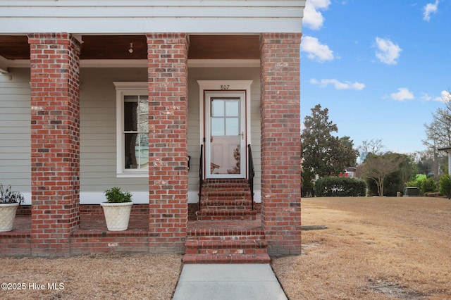 view of exterior entry with brick siding