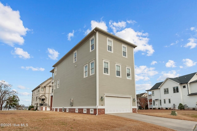 view of property exterior with a garage, concrete driveway, and a yard