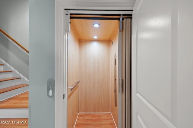 room details featuring recessed lighting, elevator, and wood finished floors