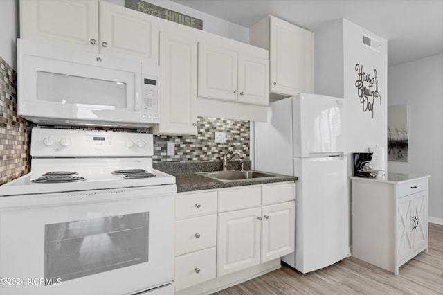 kitchen with visible vents, a sink, white cabinetry, white appliances, and light wood finished floors