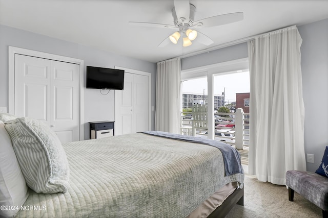 carpeted bedroom with two closets, ceiling fan, and access to exterior