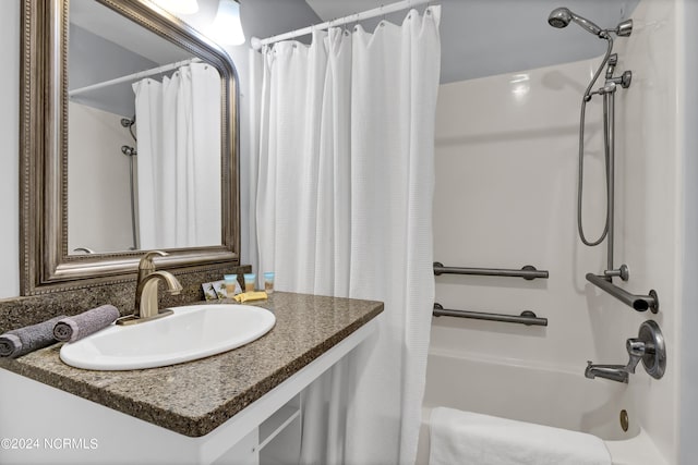 full bathroom featuring vanity and shower / bath combo with shower curtain