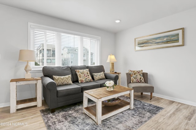 living area with recessed lighting, baseboards, and light wood finished floors