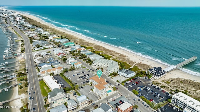 birds eye view of property featuring a view of the beach and a water view