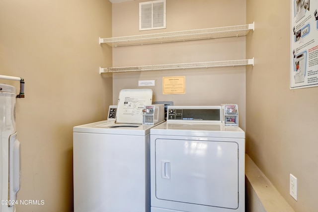 laundry area featuring laundry area, separate washer and dryer, and visible vents