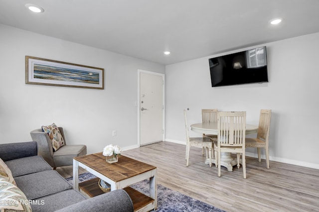 living room with recessed lighting, light wood-style floors, and baseboards