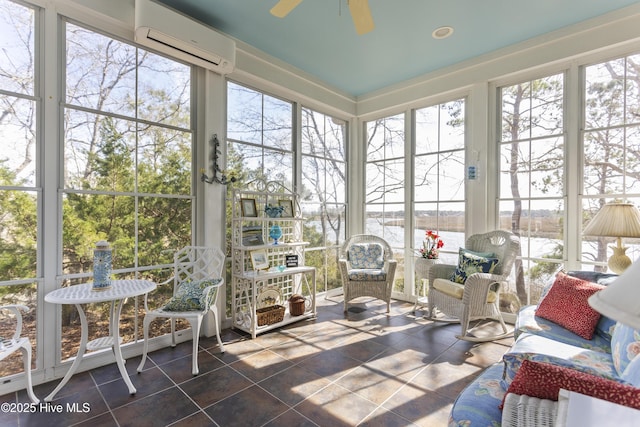 sunroom / solarium with a healthy amount of sunlight, ceiling fan, and a wall unit AC