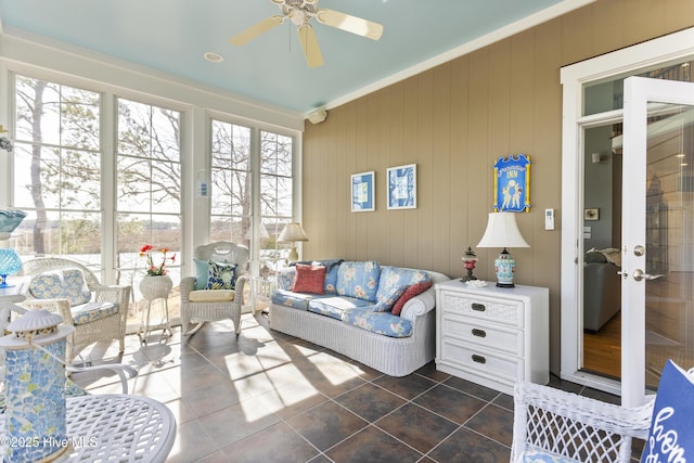 sunroom / solarium featuring ceiling fan