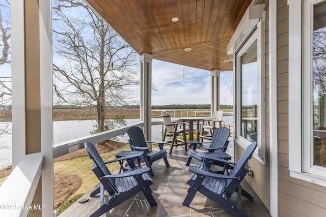 wooden deck with a water view