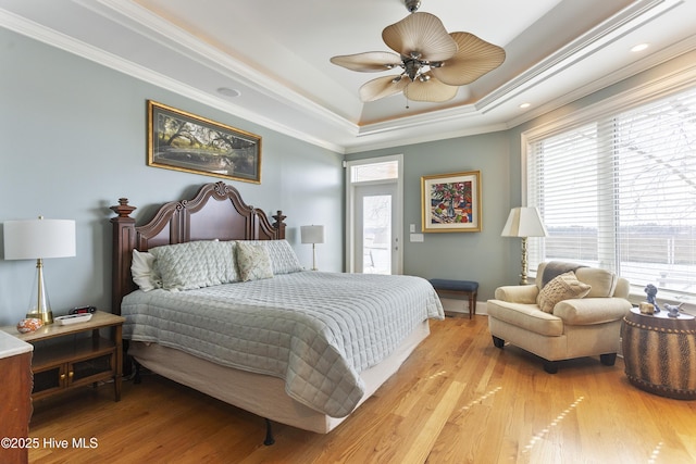 bedroom with multiple windows, crown molding, and light wood-type flooring