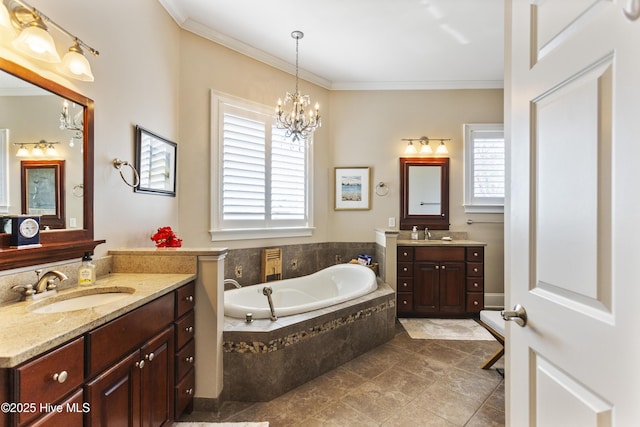 bathroom with a bath, ornamental molding, two vanities, and a sink