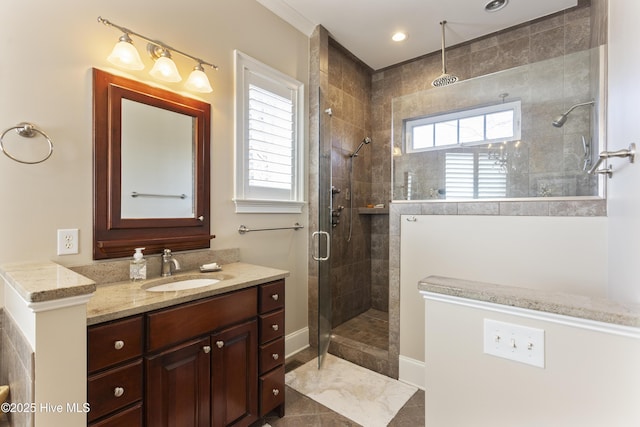 full bathroom with recessed lighting, baseboards, tiled shower, and vanity