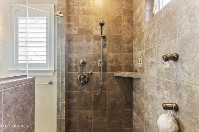 full bath with a tile shower