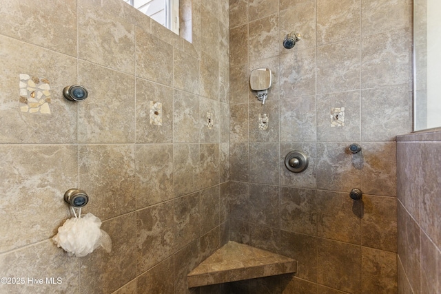 full bath featuring tiled shower