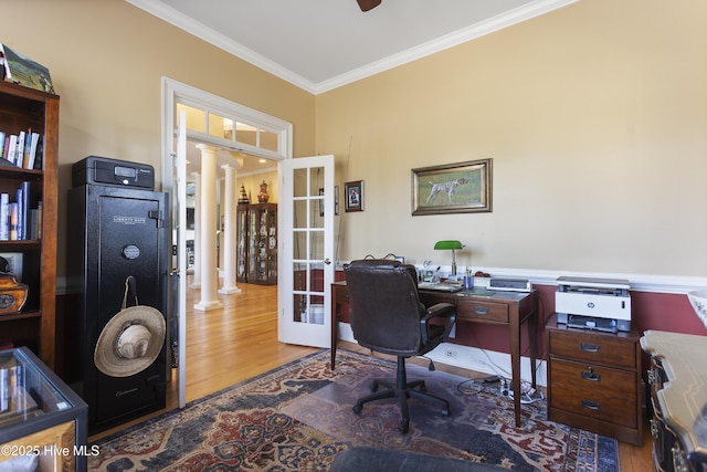 office with ornamental molding, french doors, wood finished floors, and decorative columns