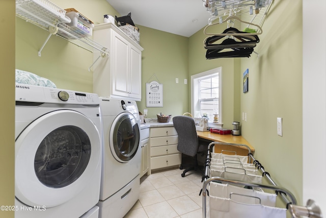 washroom featuring light tile patterned floors, cabinet space, and washing machine and clothes dryer