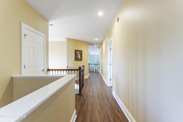 hallway with visible vents, baseboards, an upstairs landing, recessed lighting, and dark wood-style floors