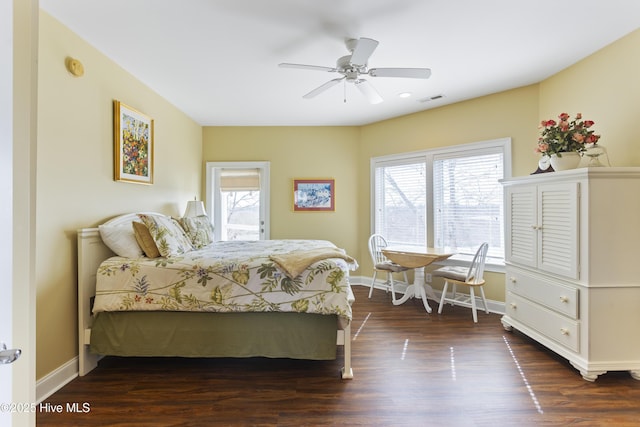 bedroom featuring ceiling fan, wood finished floors, visible vents, and baseboards